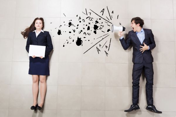 A person shouting at another person through loudspeaker